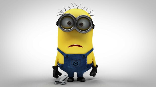 Sad minion from Despicable Me standing with a wrench on the ground