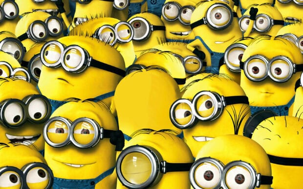 A group of Despicable Me characters with yellow bodies and goggles gathered closely together