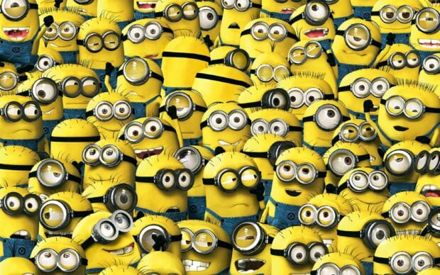 A group of minions from Despicable Me standing together with various expressions and poses