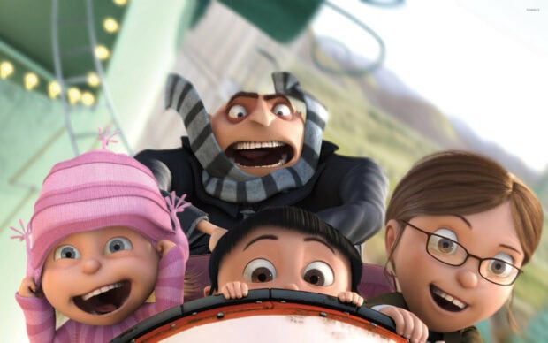 Gru and the three girls enjoying a thrilling amusement park ride in Despicable Me