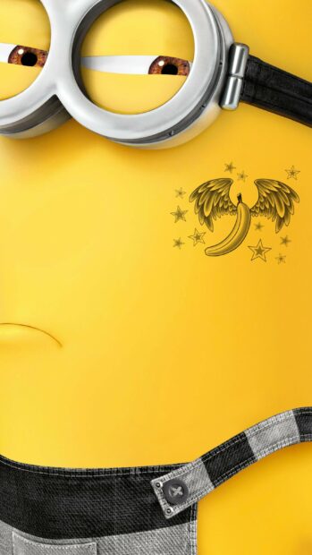 Close up of a Despicable Me character showing a banana with wings tattoo on yellow skin