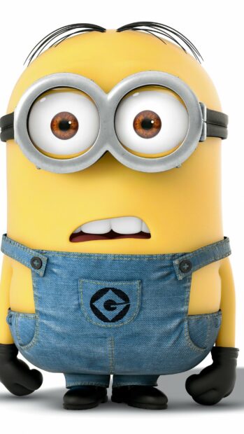 A close up of a Despicable Me character with brown eyes and denim overalls looking surprised