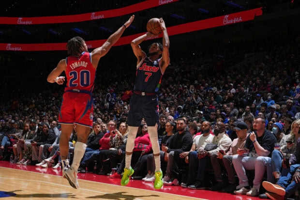 Detroit Pistons player defending against the opponent during a basketball game
