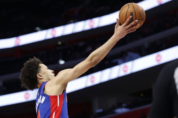 Detroit Pistons player reaching to catch a basketball during a game at the arena