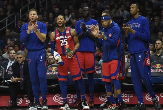 Detroit Pistons players celebrating on the bench during an intense basketball game