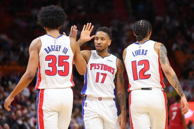 Detroit Pistons players celebrating on the court during a basketball game