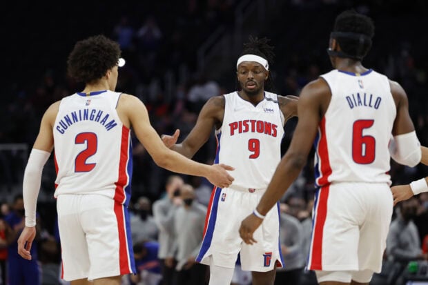 Detroit Pistons players Cunningham and Diallo celebrating on the basketball court during a game
