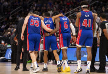 Detroit Pistons players walking together during a basketball game on the court