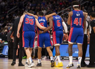 Detroit Pistons players walking together during a basketball game on the court