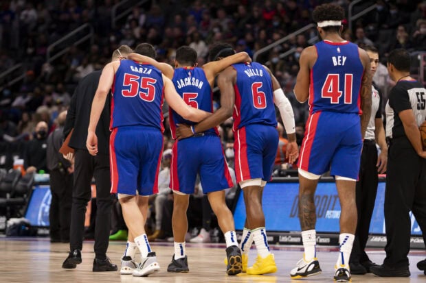 Detroit Pistons players walking together during a basketball game on the court