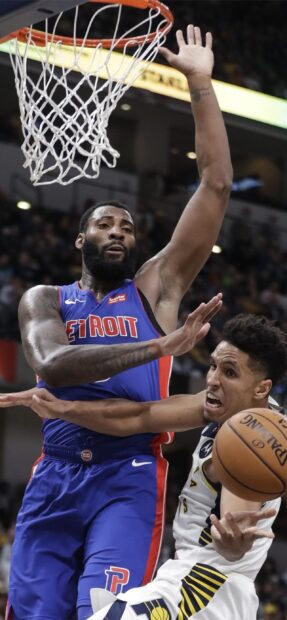 Detroit Pistons player defending against opponent during a basketball game