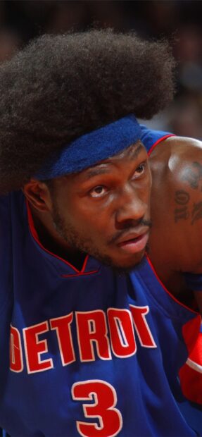 A Detroit Pistons player wearing a blue jersey with the number 3 and a blue headband