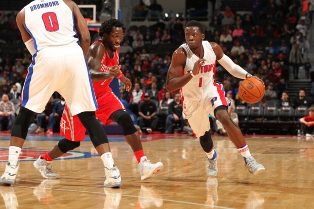 Detroit Pistons player dribbling the basketball during an intense game against opponents