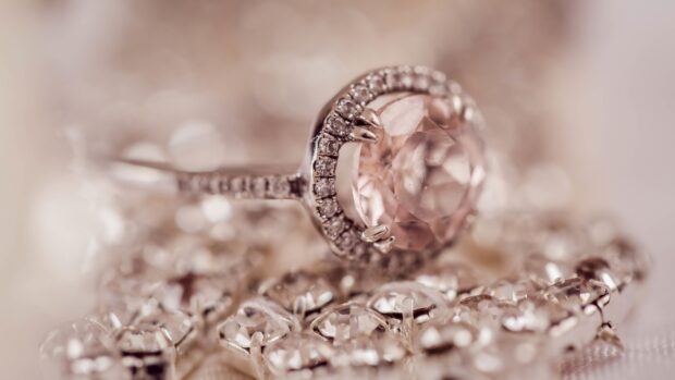 Close up of diamond jewelry featuring a pink gemstone and intricate metalwork