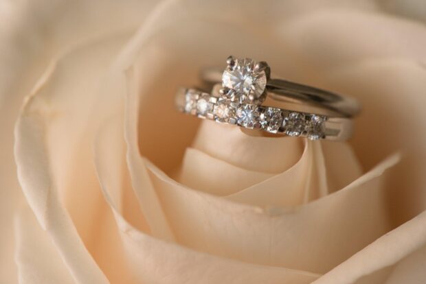 Diamond jewelry placed inside a soft cream rose showing sparkling stones and intricate design