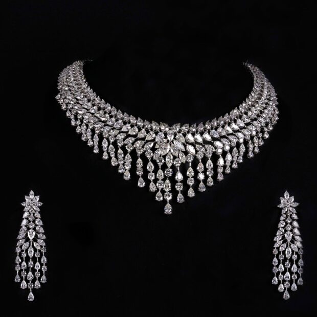 Elegant diamond jewelry set with intricate necklace and matching earrings on black background