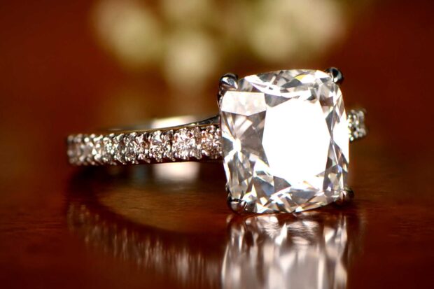 Close up of diamond jewelry on a reflective surface showcasing exquisite diamond jewelry craftsmanship