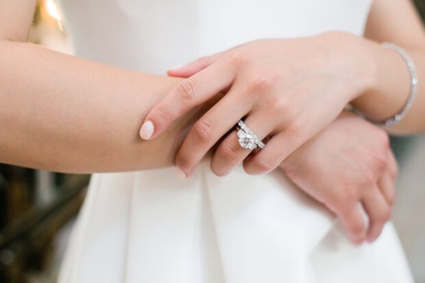 A close up of diamond jewelry rings on a hand showing exquisite diamond jewelry