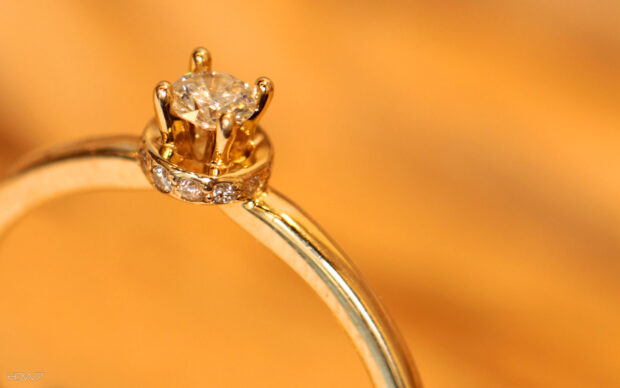 A close up of diamond jewelry showcasing a sparkling diamond in a gold setting