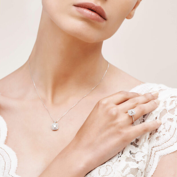 Elegant diamond jewelry necklace and ring on woman wearing lace dress