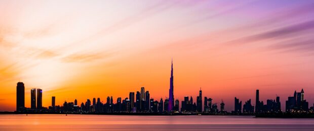 Dubai skyline at sunset with stunning colorful sky and tall buildings silhouette
