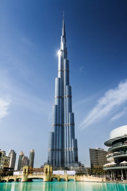 The Dubai skyline features the iconic tallest building under a clear blue sky