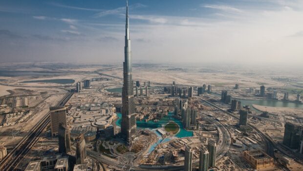 Aerial view of Dubai skyline featuring the iconic Burj Khalifa in a desert cityscape