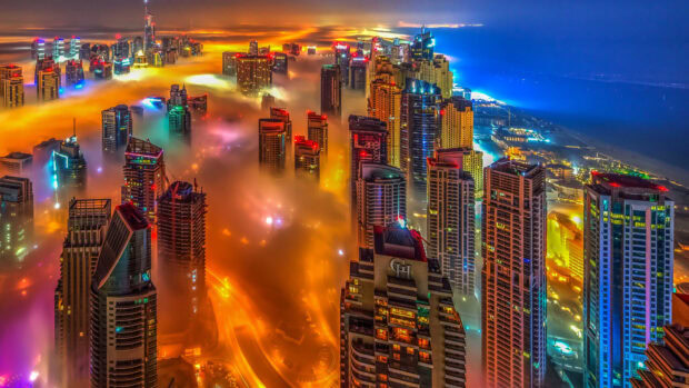 Vibrant Dubai skyline covered with colorful fog at night showcasing modern skyscrapers in 4K quality