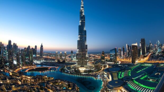 Dubai skyline at twilight with the Burj Khalifa and city lights illuminating the scene