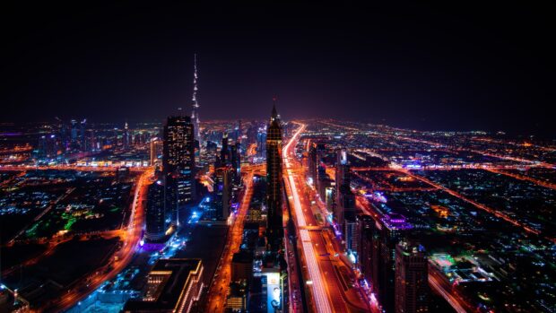 Dubai skyline featuring illuminated roads and skyscrapers at night