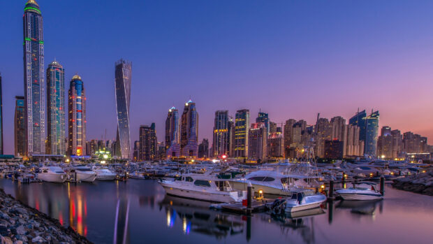 Dubai skyline with boats docked at marina during sunset in 4k quality
