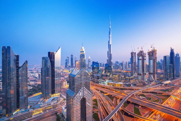 Stunning Dubai skyline with modern skyscrapers and intricate highway network at dusk