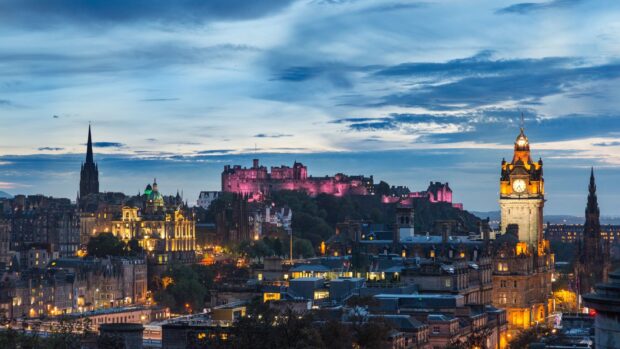 The Edinburgh skyline at dusk showcasing historic buildings and landmarks against a dramatic sky