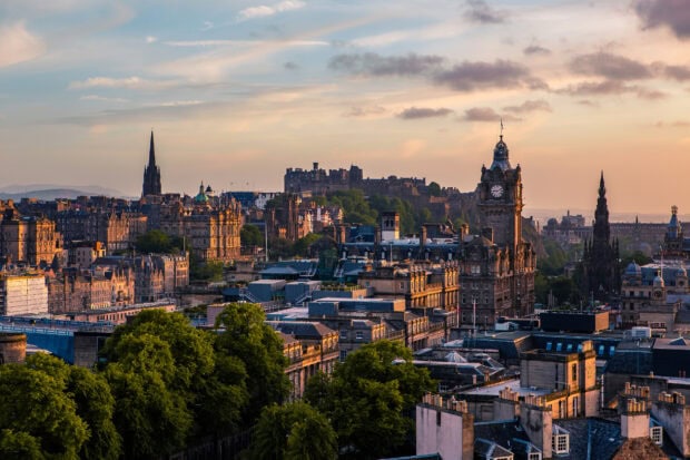 Historic Edinburgh skyline featuring iconic buildings and cityscape at sunset