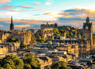 Edinburgh skyline featuring historic architecture and landmarks under a dramatic sunset sky