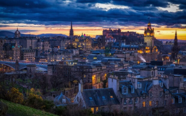Historic cityscape of Edinburgh skyline with famous landmarks at sunset