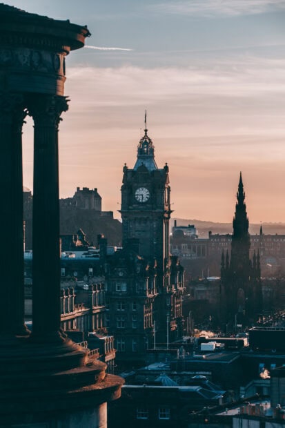 View of Edinburgh skyline with historic clock tower and sunset sky in HD quality