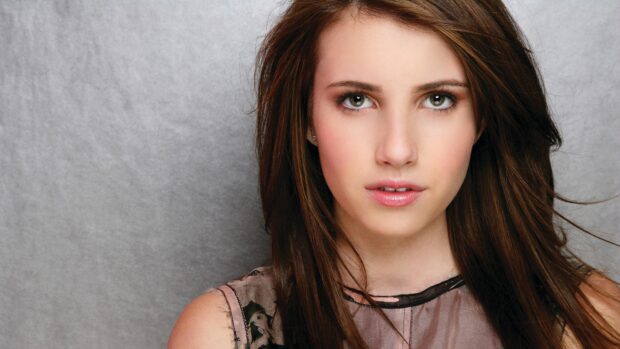 Emma Roberts with brown hair and green eyes looking directly at the camera