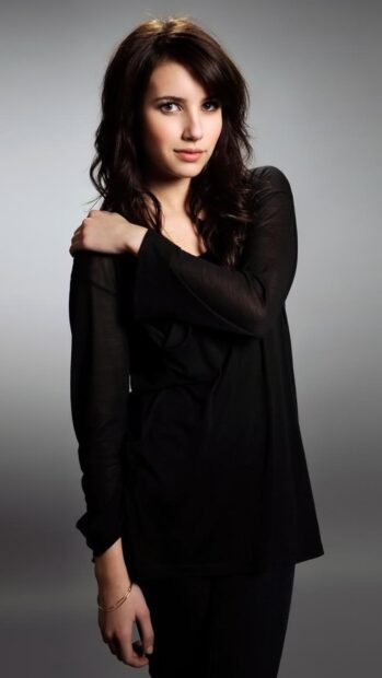 Young woman Emma Roberts posing with black outfit and neutral expression