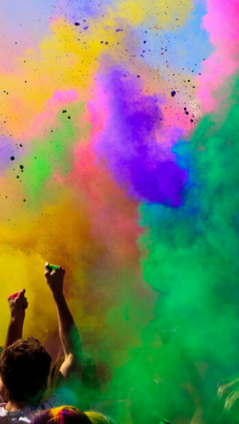 People celebrating with colorful powders in a festival celebration