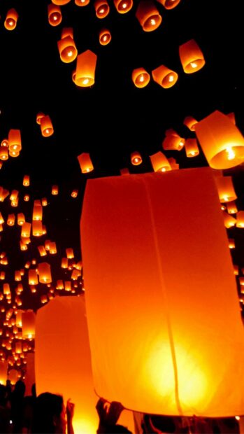 People release glowing lanterns during festival night sky celebration