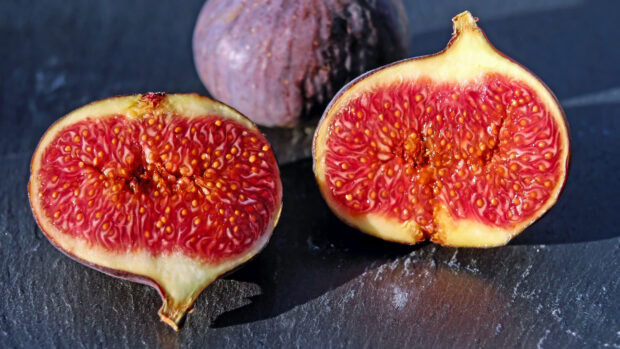Close up of fresh fig fruit cut in half showing detailed seeds and texture
