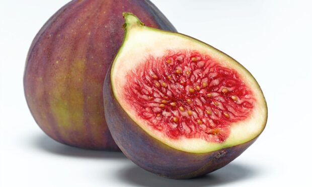 Fresh fig close up showing the red pulp and seeds inside the fruit