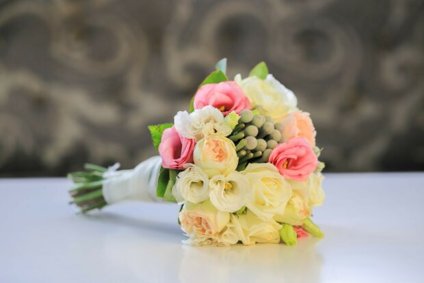 A delicate flower bouquet with pink and white blooms arranged elegantly on a table