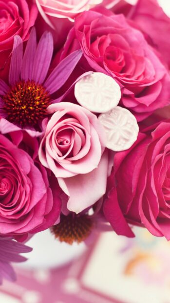 Pink flower bouquet with roses and purple petals in close up view