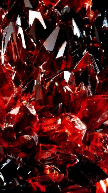 Close up of red gemstone cluster with sharp crystal formations