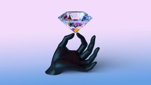 A black hand holding a sparkling gemstone with vibrant reflections against a gradient background