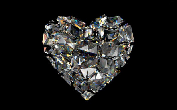 Heart shaped gemstone pieces sparkling on a black background