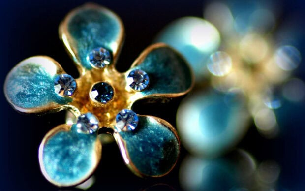 Close up of gemstone flower with blue petals and shiny gems in center