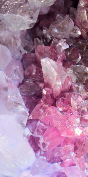Close up of vibrant pink gemstone with clear crystal formations